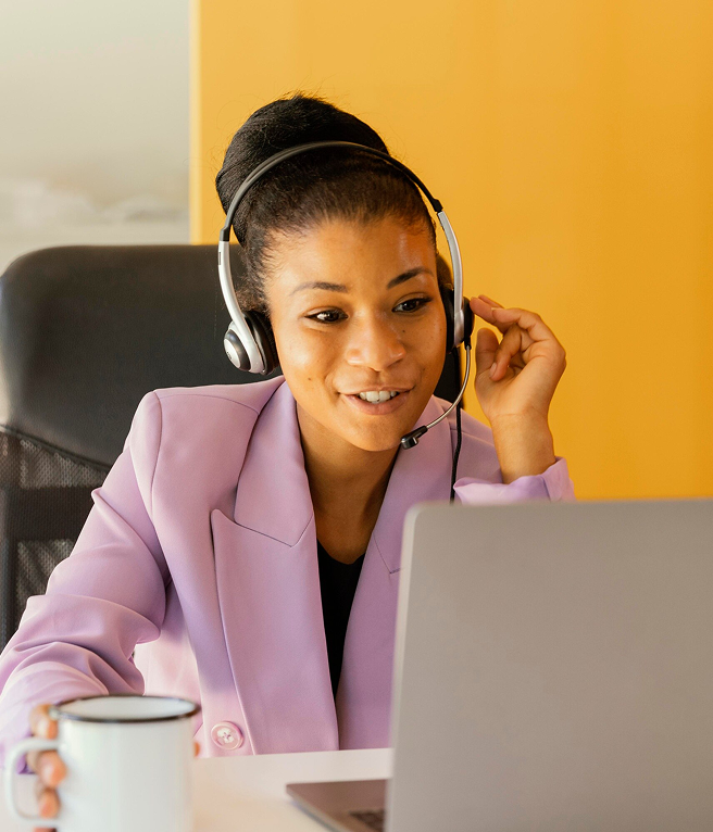 Woman in pink blazer working at computer